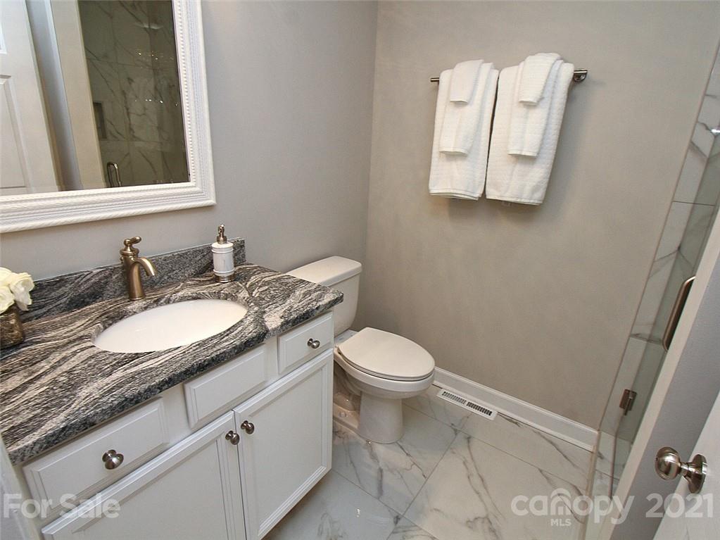 405 Fieldstone Road Mooresville, NC 28115 - Photo 35 of 46 a bathroom with a granite countertop toilet sink and mirror