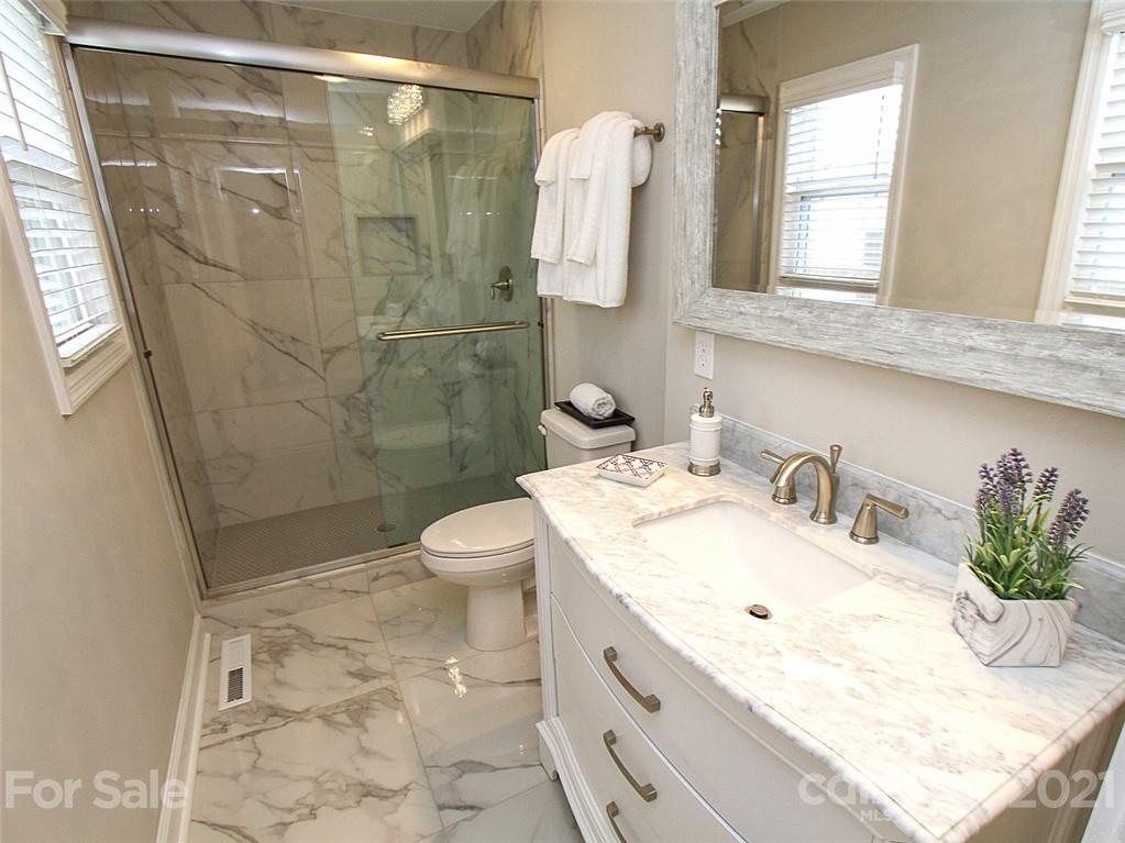 405 Fieldstone Road Mooresville, NC 28115 - Photo 38 of 46 a bathroom with a granite countertop sink a toilet and shower