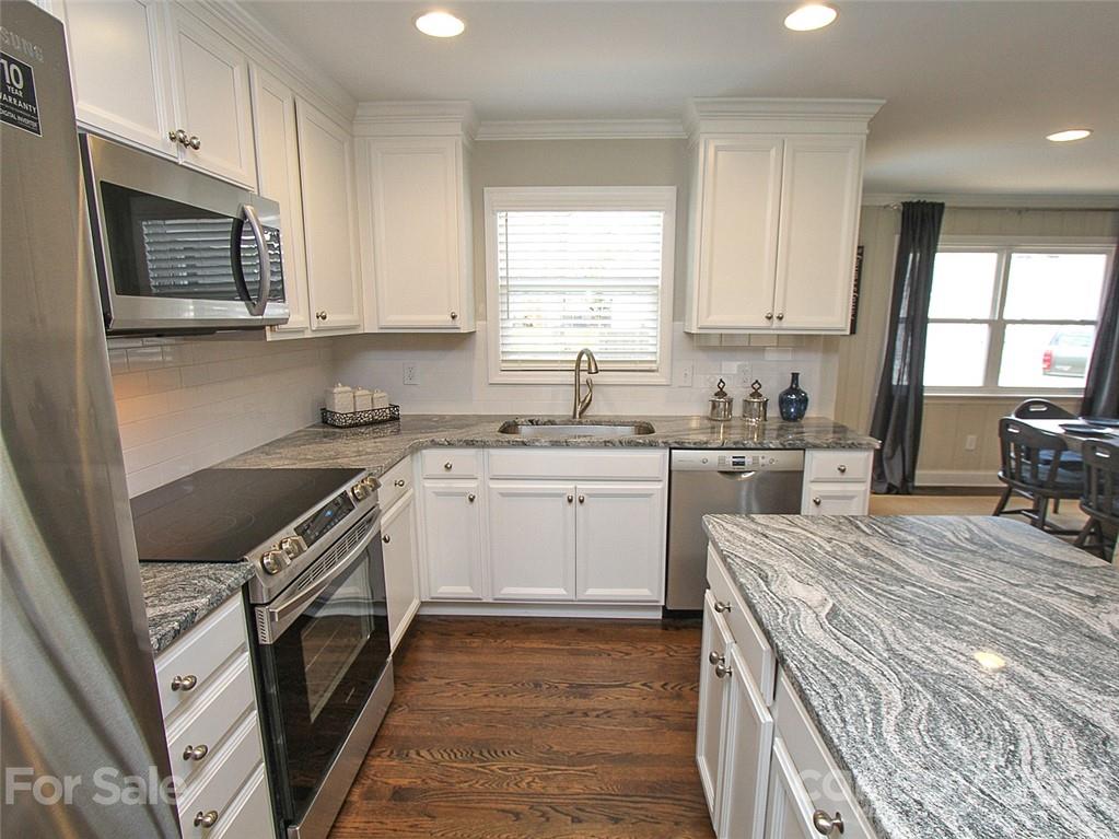 405 Fieldstone Road Mooresville, NC 28115 - Photo 6 of 46 a kitchen with a stove a sink and a microwave