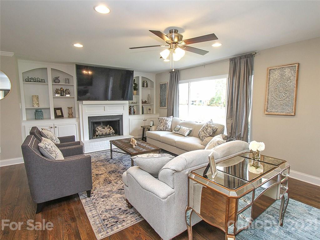 405 Fieldstone Road Mooresville, NC 28115 - Photo 8 of 46 a living room with furniture a fireplace and a flat screen tv