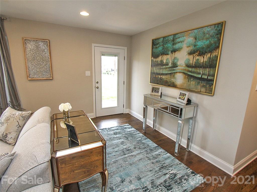 405 Fieldstone Road Mooresville, NC 28115 - Photo 9 of 46 a living room with furniture a flat screen tv and a fireplace