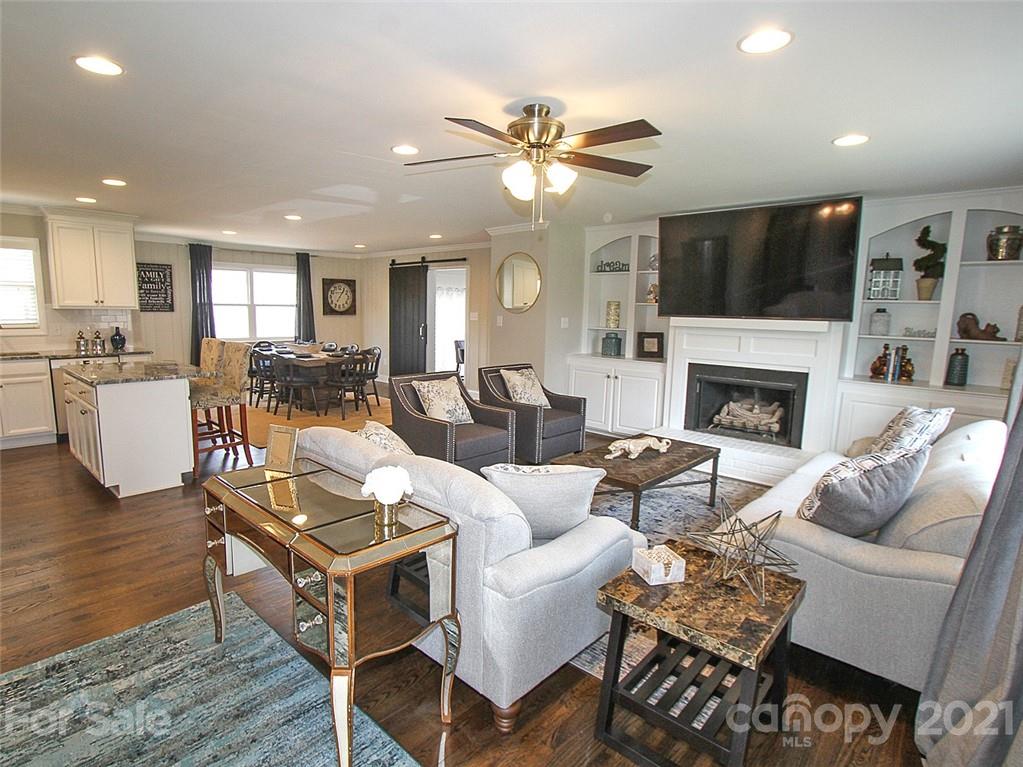 405 Fieldstone Road Mooresville, NC 28115 - Photo 10 of 46 a living room with fireplace furniture and a flat screen tv