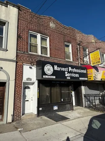 a view of a building with retail shops and traffic signal