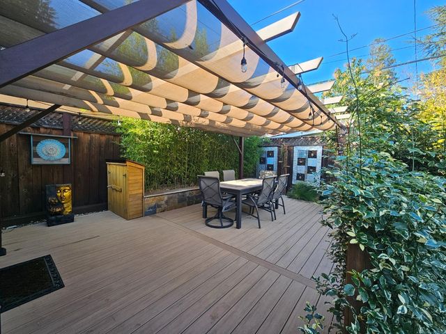 a roof deck with table and chairs a barbeque with potted plants