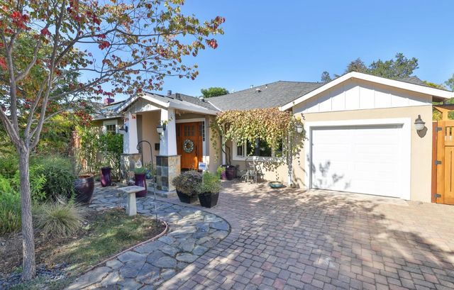 a view of a house with a tree in the background
