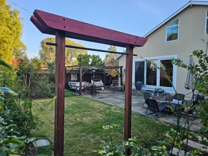 a view of a house with backyard and sitting area