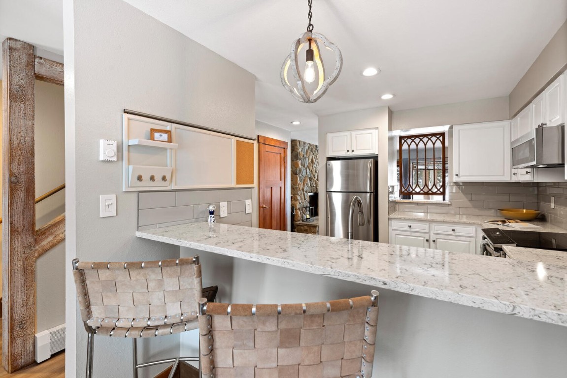 1928 Soda Ridge Road, Unit 1226 Keystone, CO 80435 - Photo 11 of 34 a large kitchen with stainless steel appliances granite countertop a sink refrigerator and cabinets