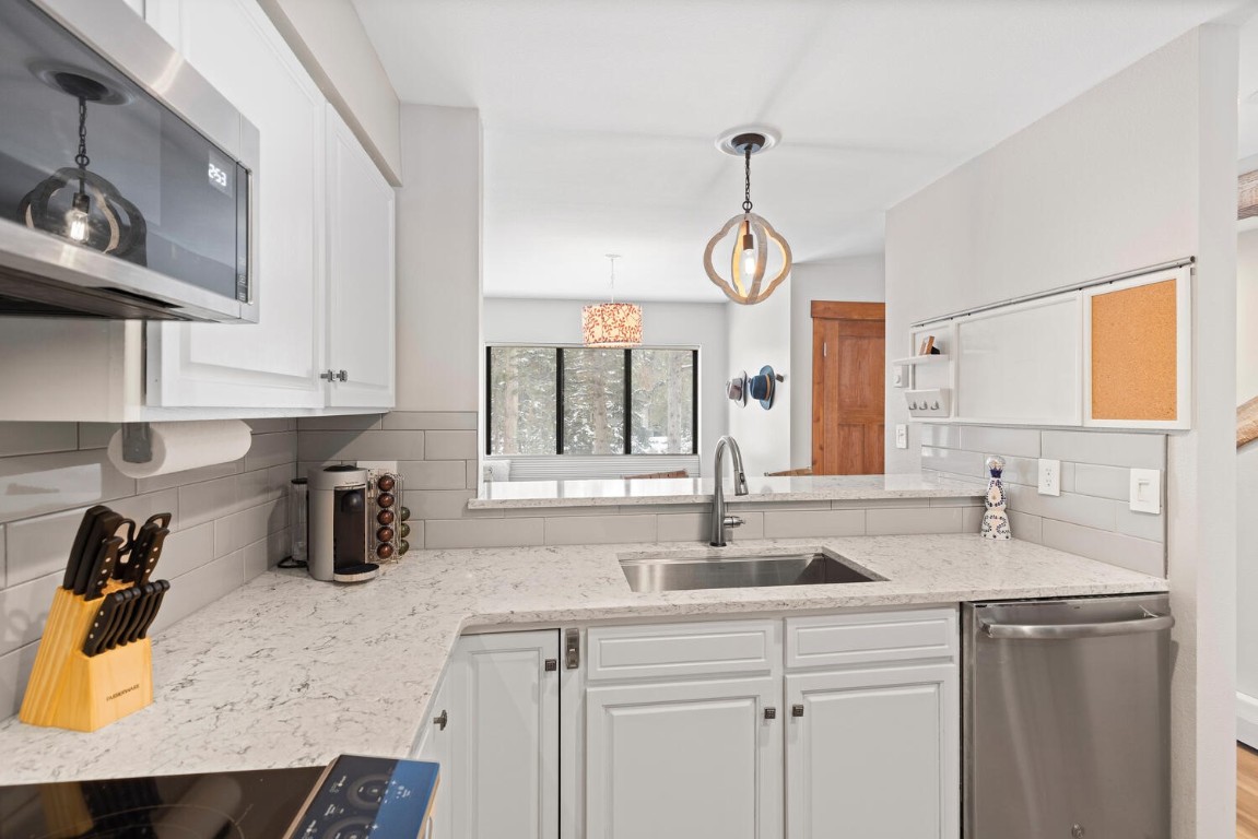 1928 Soda Ridge Road, Unit 1226 Keystone, CO 80435 - Photo 14 of 34 a kitchen with stainless steel appliances granite countertop a sink a stove and cabinets