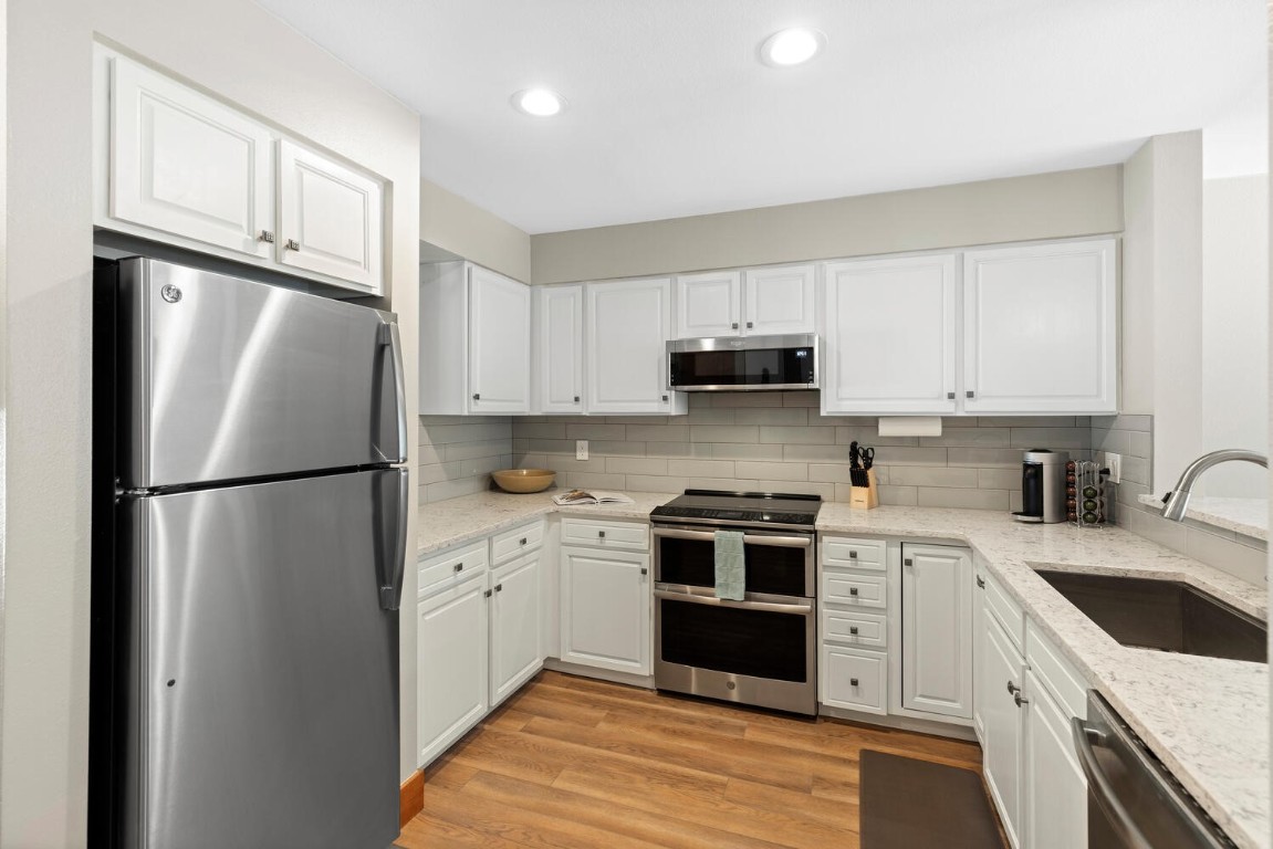 1928 Soda Ridge Road, Unit 1226 Keystone, CO 80435 - Photo 16 of 34 a kitchen with cabinets stainless steel appliances and a sink