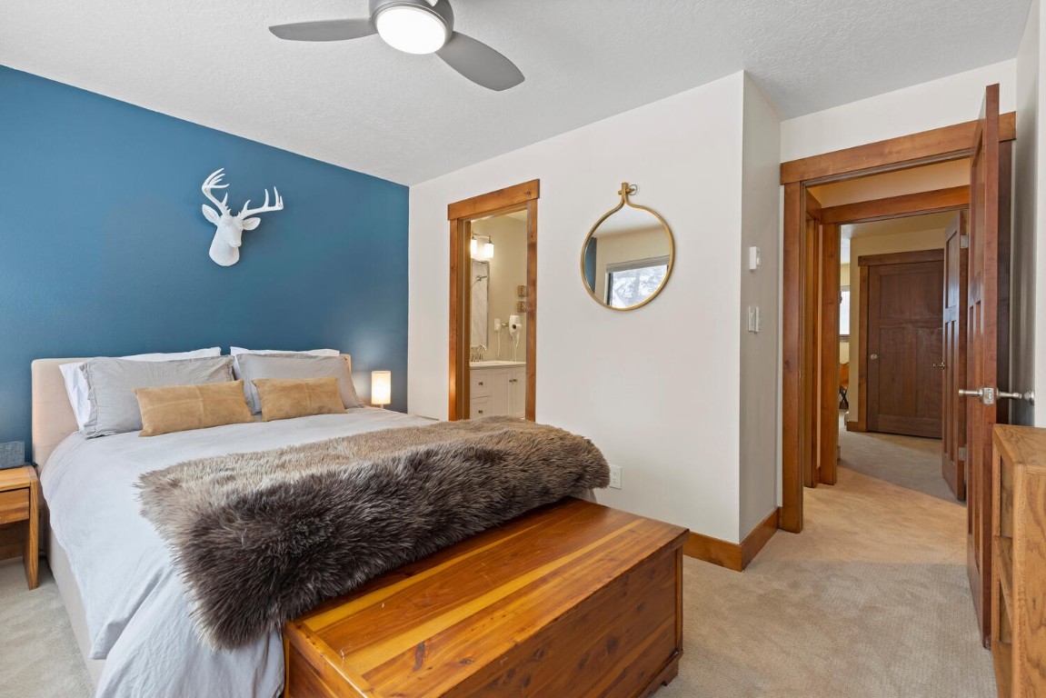 1928 Soda Ridge Road, Unit 1226 Keystone, CO 80435 - Photo 21 of 34 a bedroom with a bed and a chandelier