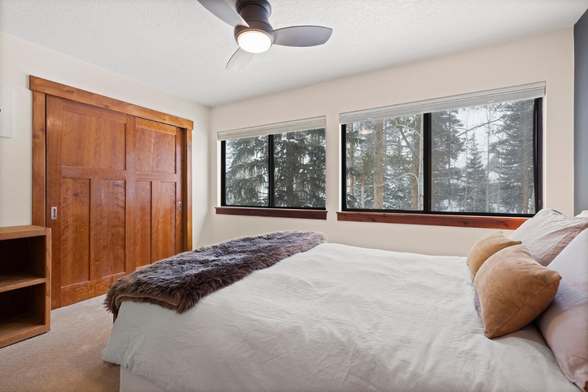 1928 Soda Ridge Road, Unit 1226 Keystone, CO 80435 - Photo 24 of 34 a bedroom with a large bed and a large window