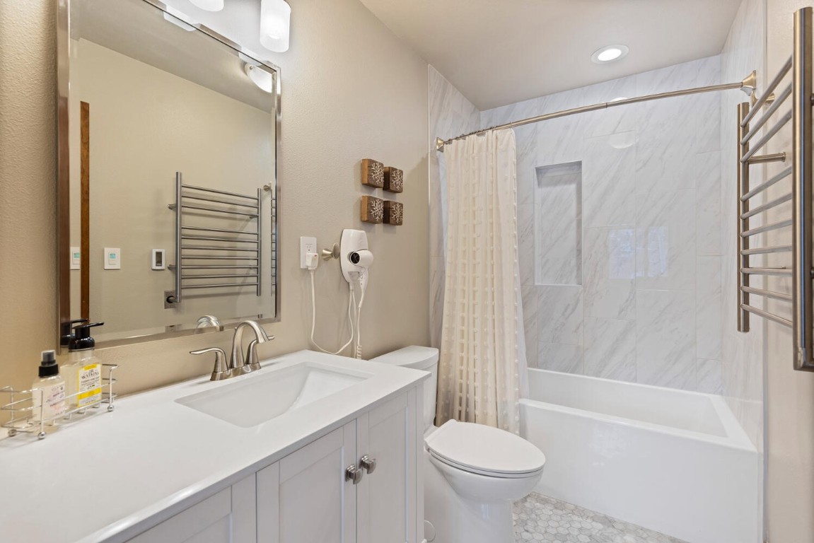 1928 Soda Ridge Road, Unit 1226 Keystone, CO 80435 - Photo 25 of 34 a bathroom with a sink toilet and shower