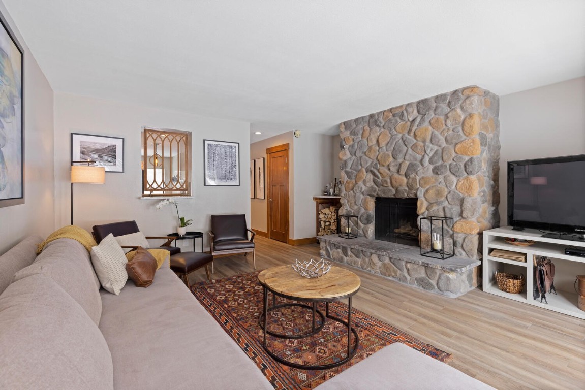 1928 Soda Ridge Road, Unit 1226 Keystone, CO 80435 - Photo 4 of 34 a living room with furniture a flat screen tv and a fireplace