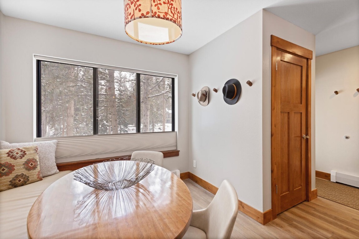 1928 Soda Ridge Road, Unit 1226 Keystone, CO 80435 - Photo 10 of 34 a view of a dining room with furniture and wooden floor