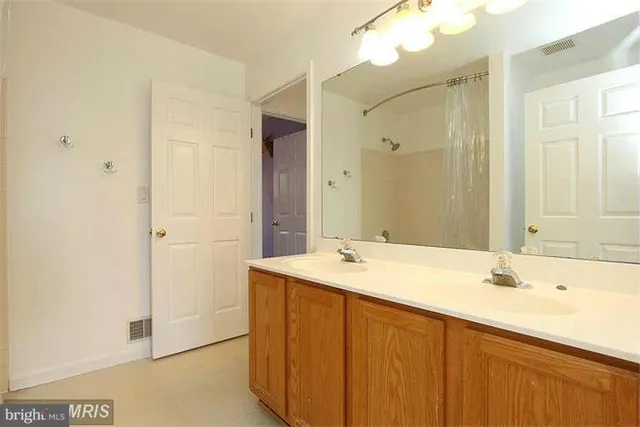 a bathroom with a sink a mirror and a bathtub