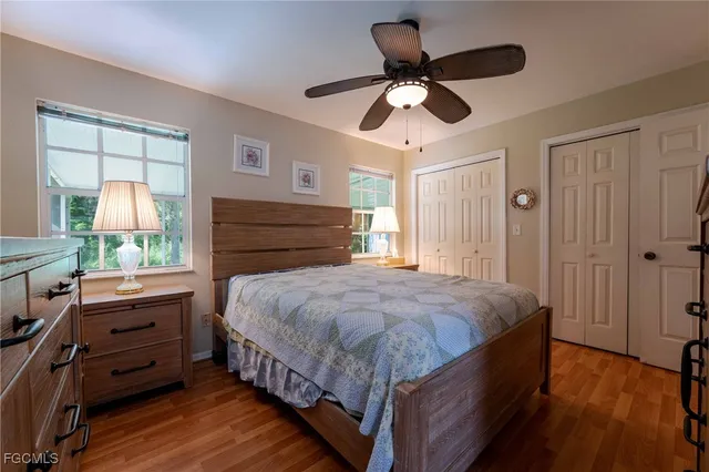 a bedroom with a bed chandelier and a window