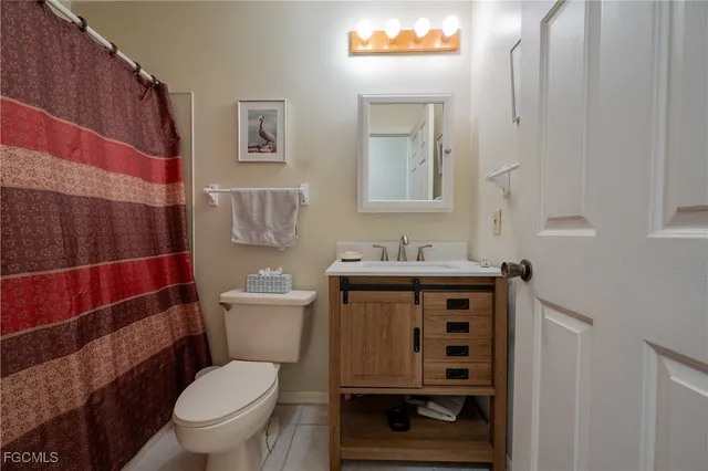 a bathroom with a toilet sink and shower