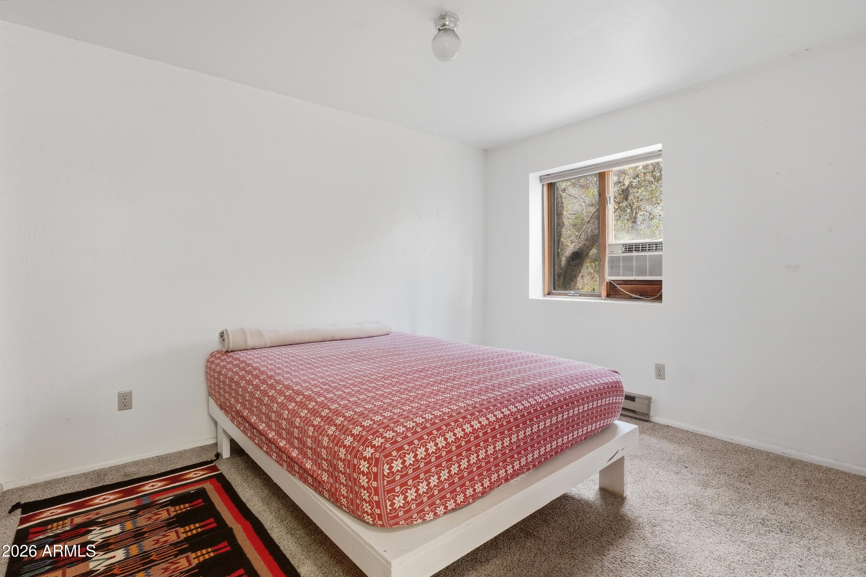 8135 West Gibson Ranch Road Payson, AZ 85541 - Photo 15 of 43 a bedroom with a bed and a window