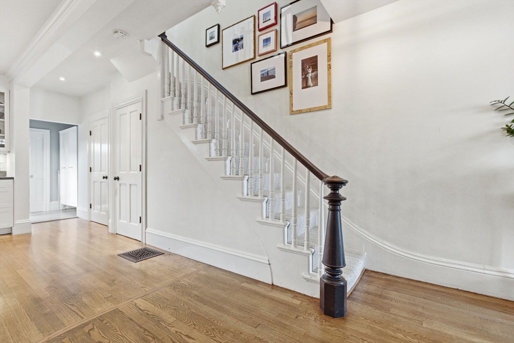 38 Bartlett Street Boston, MA 02129 - Photo 16 of 37 a view of entryway with wooden floor and stairs