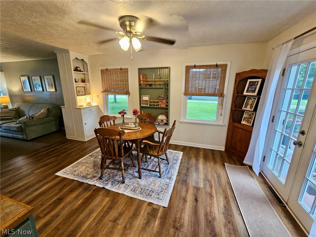 6620 West Lake Road Vermilion, OH 44089 - Photo 17 of 34 Wood-finish flooring throughout, built-in shelving, ceiling fan with light fixture, and French doors