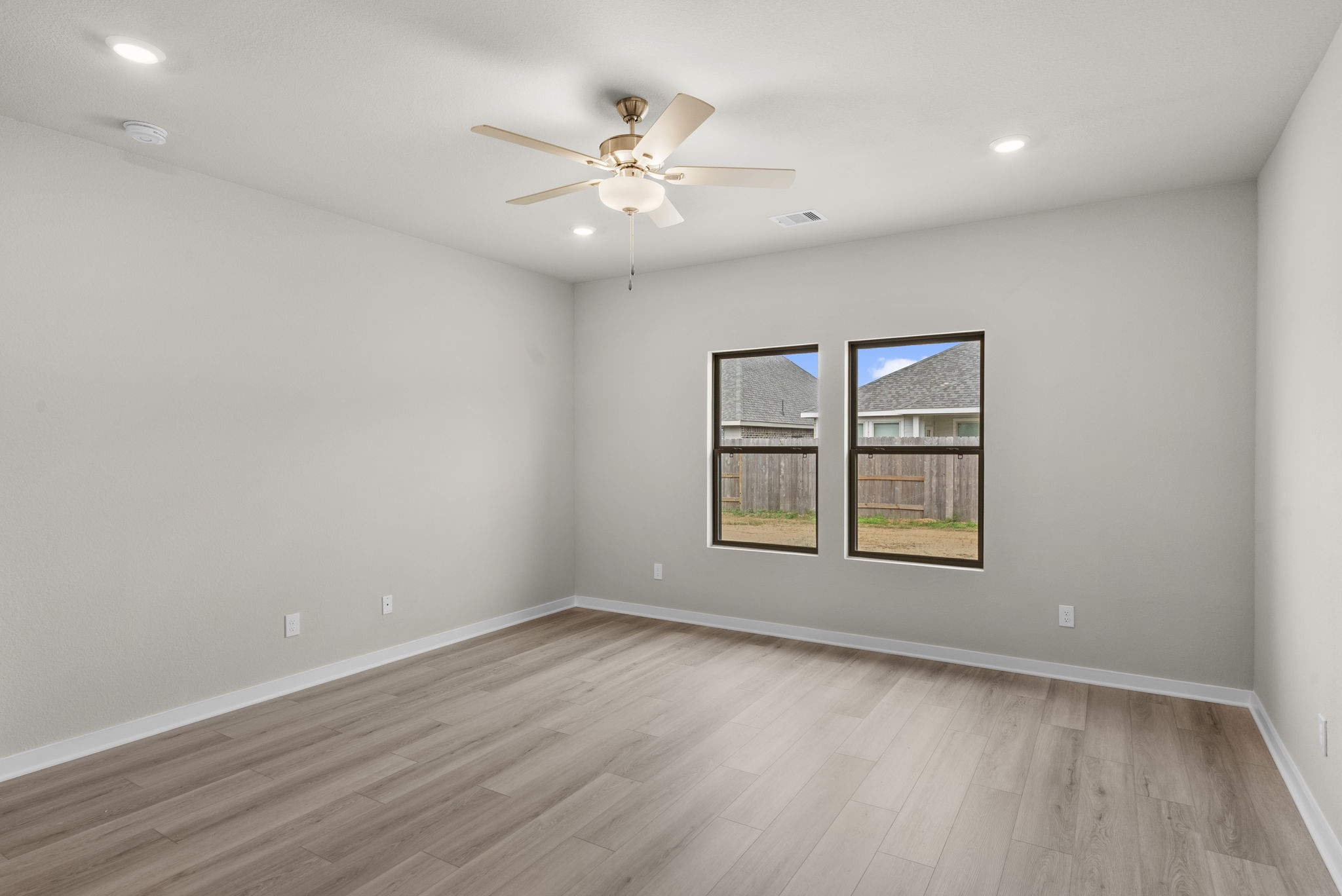 1911 Stargazer Lane Angleton, TX 77515 - Photo 12 of 33 an empty room with wooden floor and windows