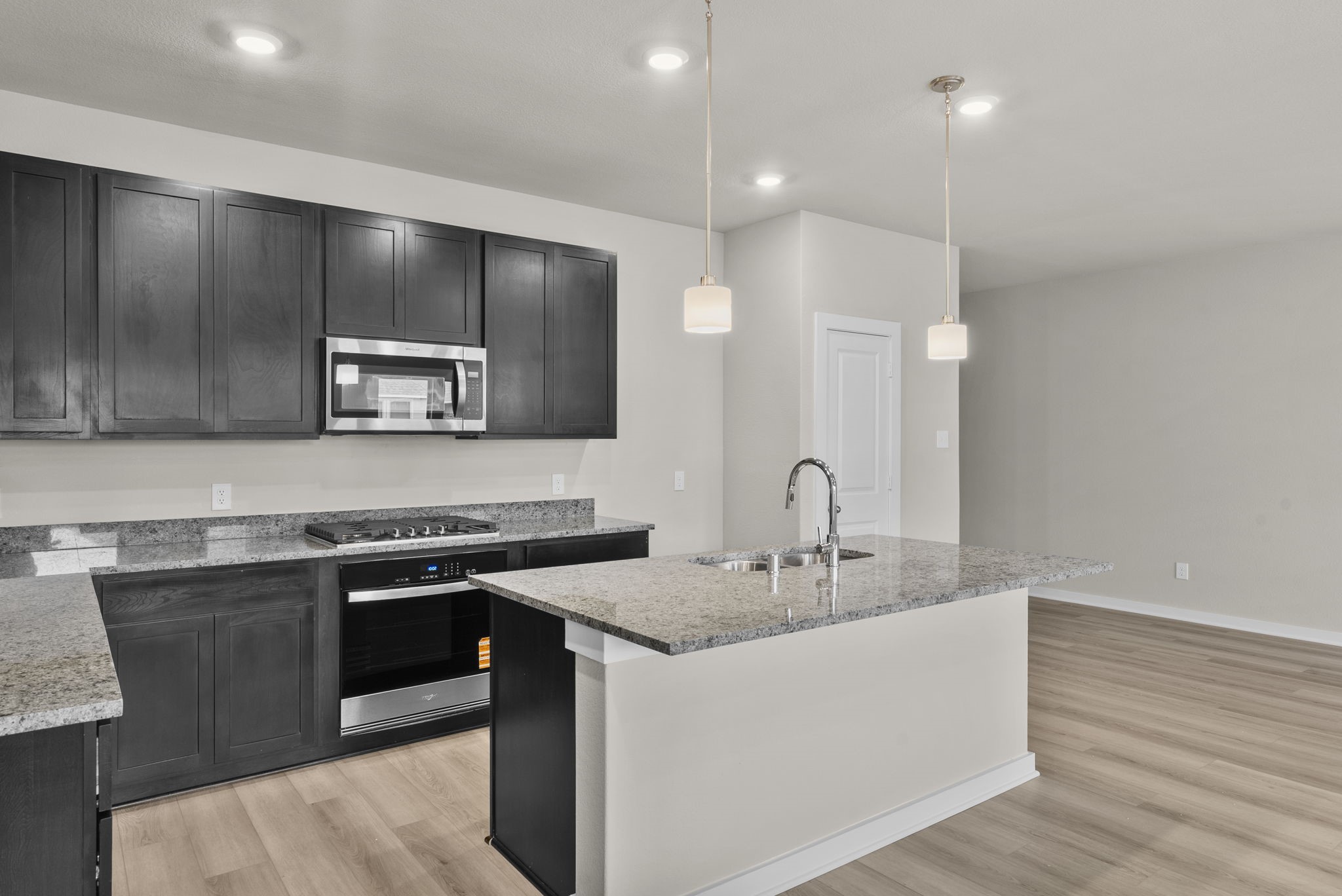1911 Stargazer Lane Angleton, TX 77515 - Photo 5 of 33 a kitchen with a sink and stove top oven