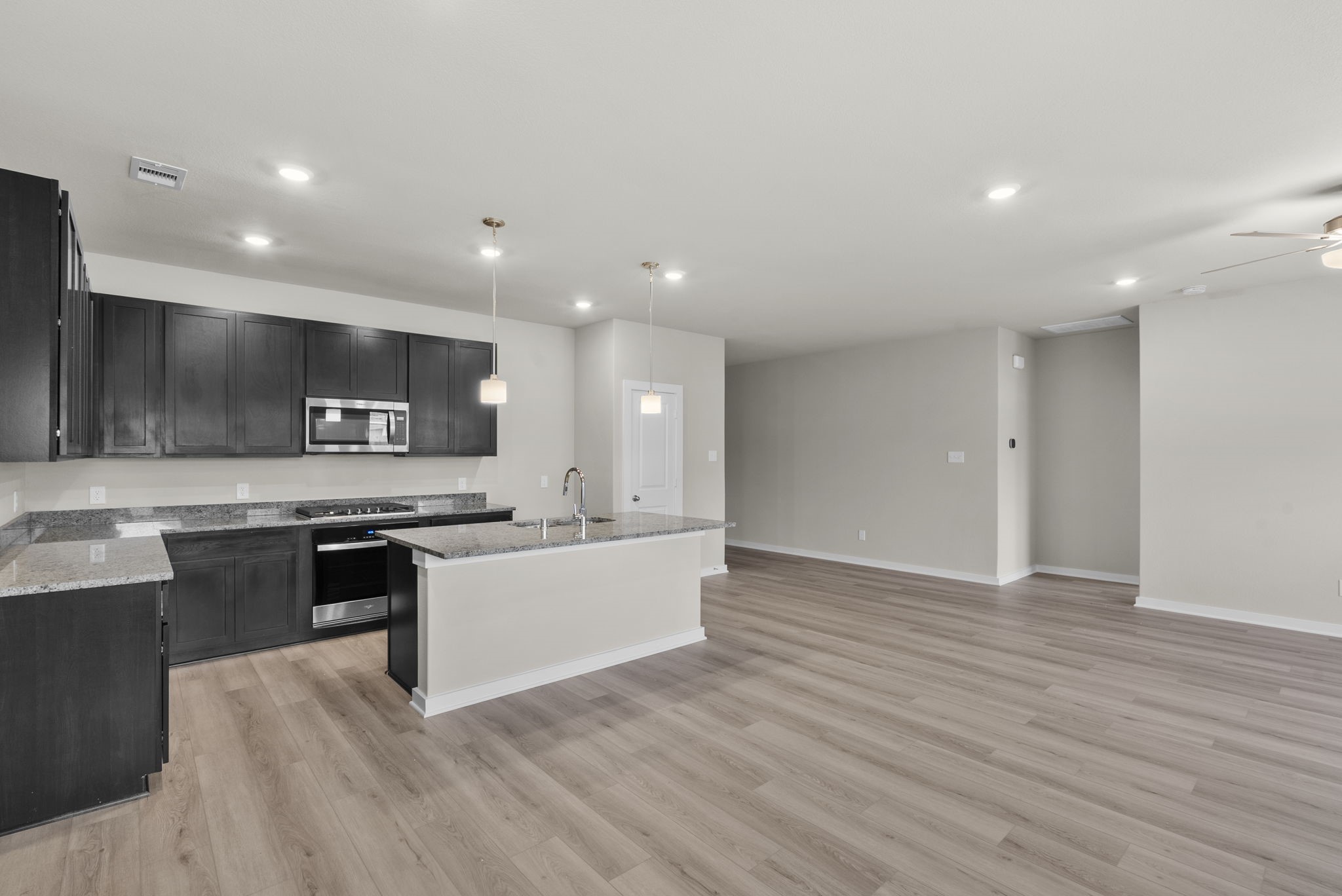 1911 Stargazer Lane Angleton, TX 77515 - Photo 8 of 33 a large kitchen with stainless steel appliances a large counter top a stove and a refrigerator
