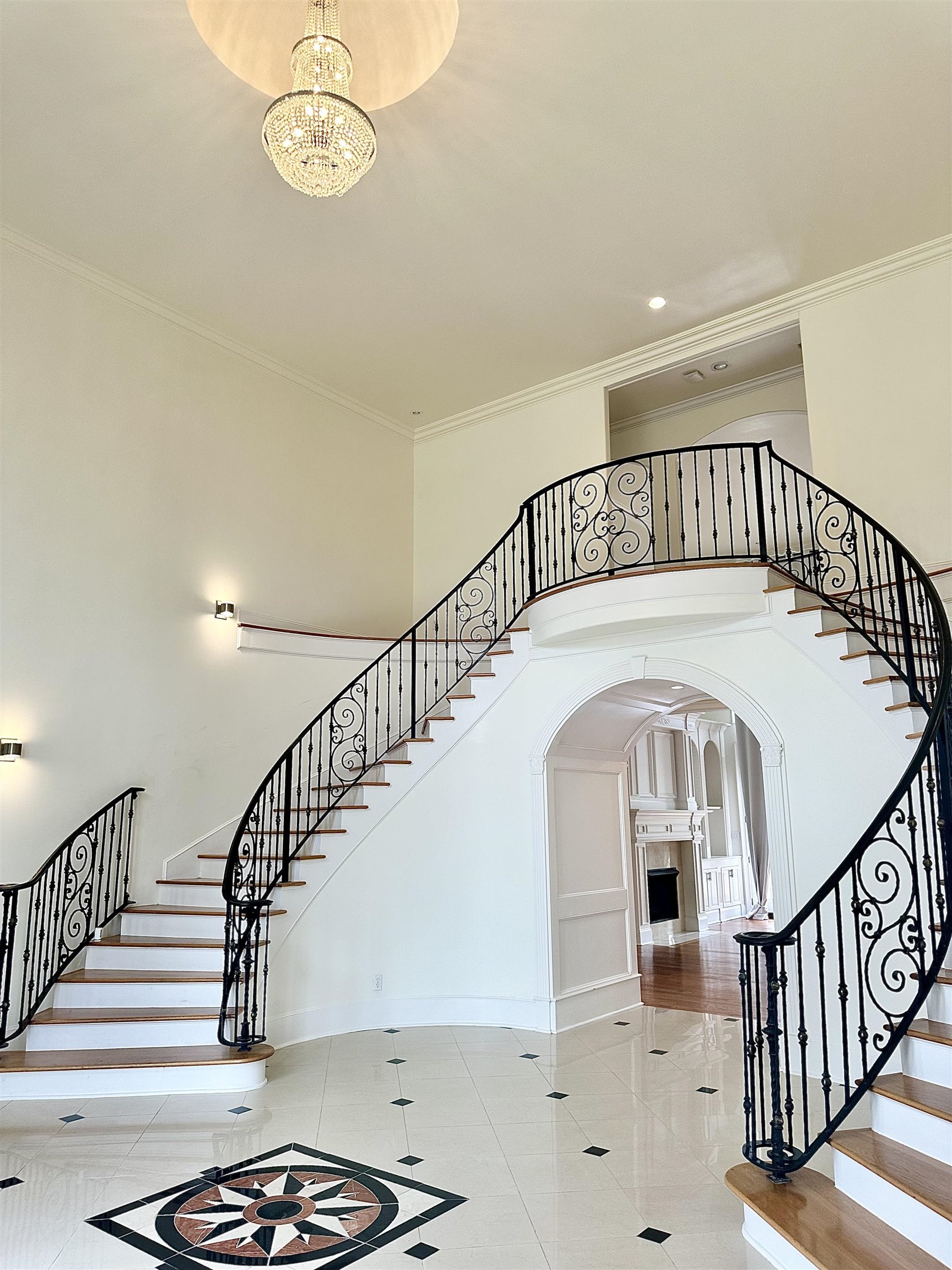205 Jamerson Farm Road Collierville, TN 38017 - Photo 3 of 36 Stairway featuring a notable chandelier, crown molding, arched walkways, and a high ceiling