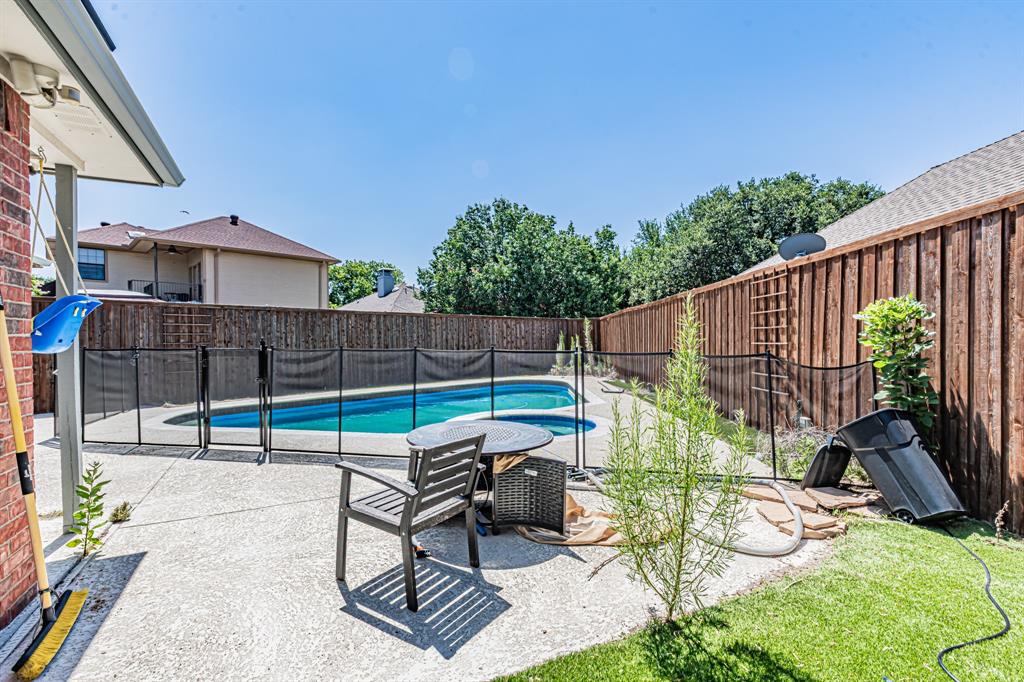 300 Sundance Circle Irving, TX 75063 - Photo 36 of 39 Concrete patio featuring a fenced swimming pool with a blue liner, a wood privacy fence, and a grass lawn