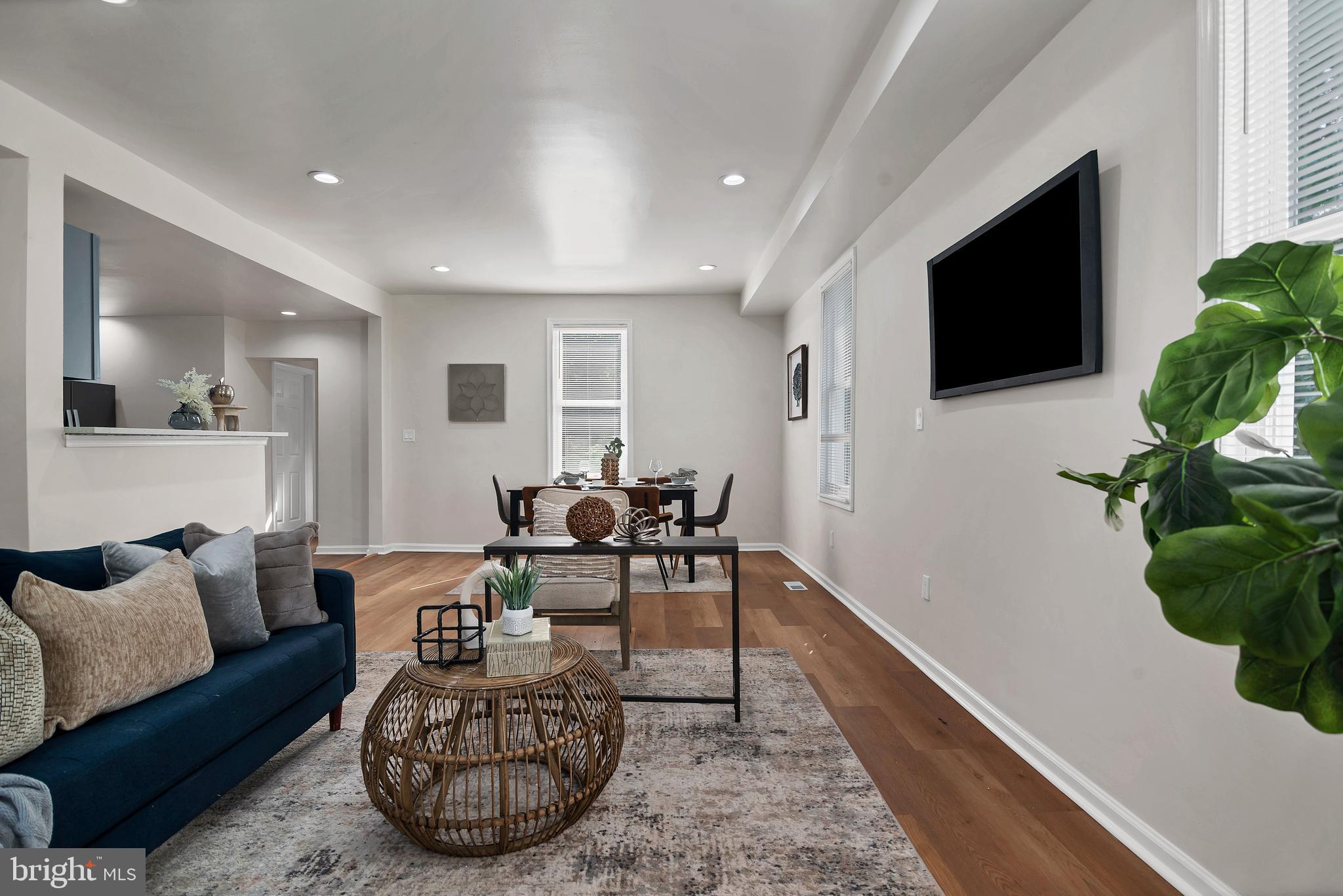 4132 Marx Avenue Baltimore, MD 21206 - Photo 12 of 76 a living room with furniture a flat screen tv and a potted plant