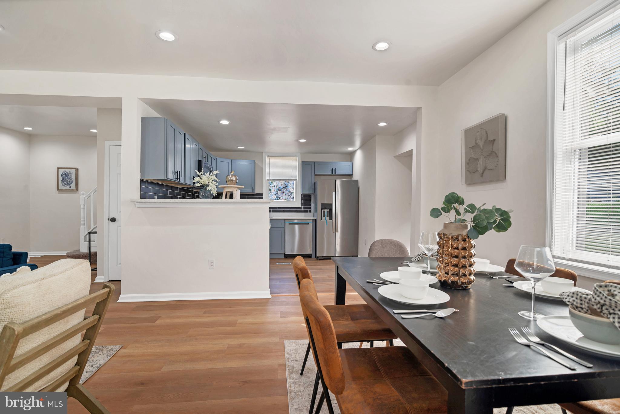 4132 Marx Avenue Baltimore, MD 21206 - Photo 15 of 76 a kitchen with a table chairs refrigerator and microwave