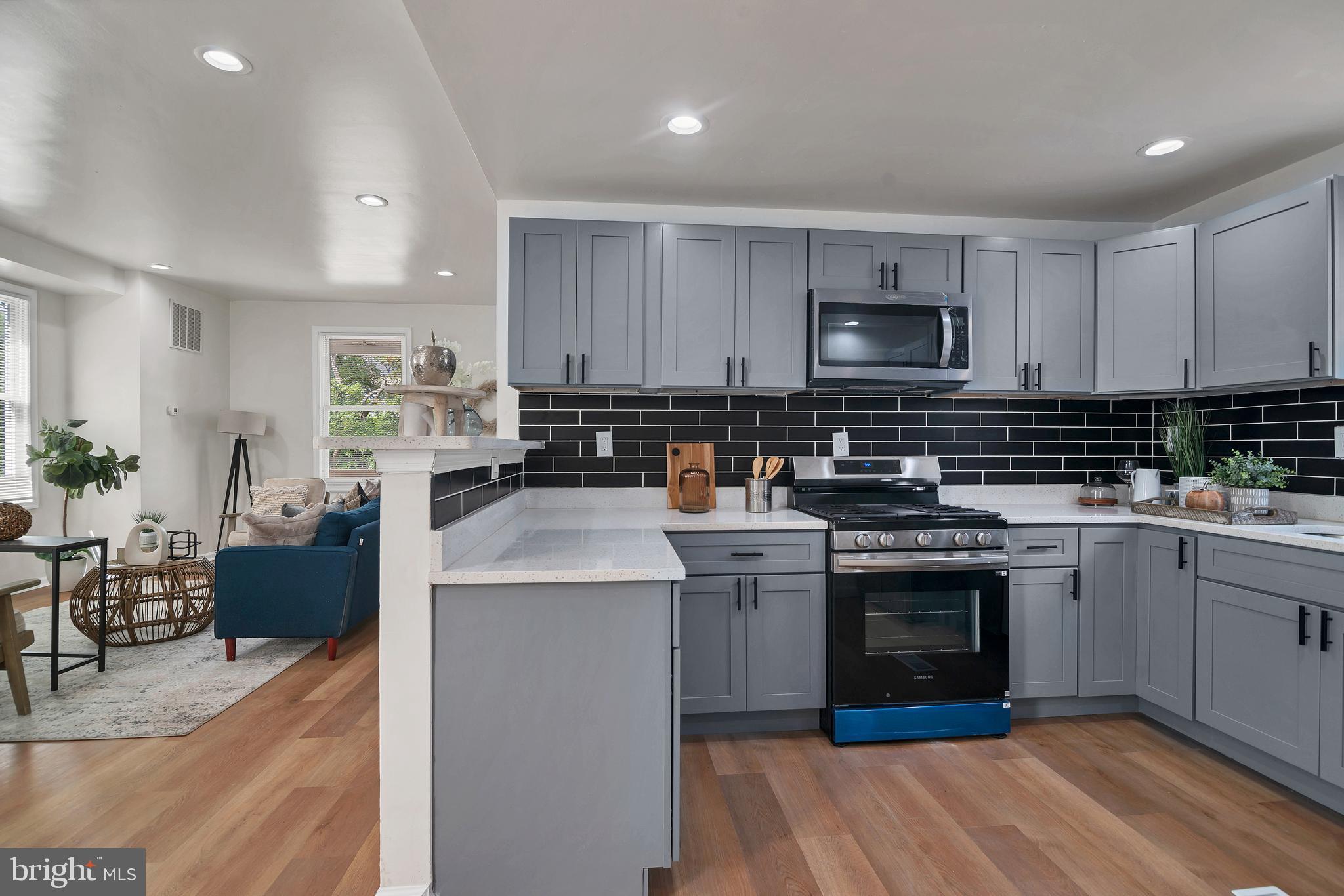 4132 Marx Avenue Baltimore, MD 21206 - Photo 16 of 76 a kitchen with stainless steel appliances granite countertop a stove top oven a sink a counter space and cabinets
