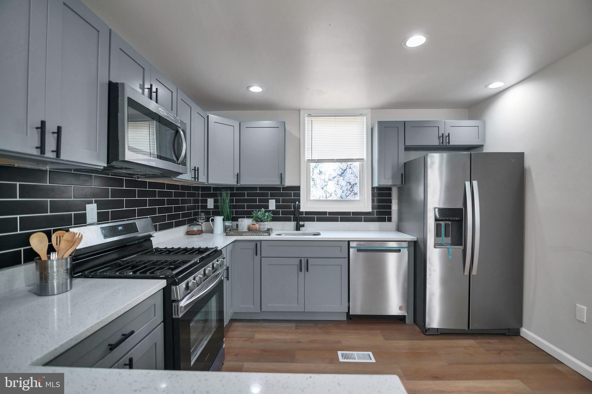 4132 Marx Avenue Baltimore, MD 21206 - Photo 20 of 76 a kitchen with a sink stove and refrigerator