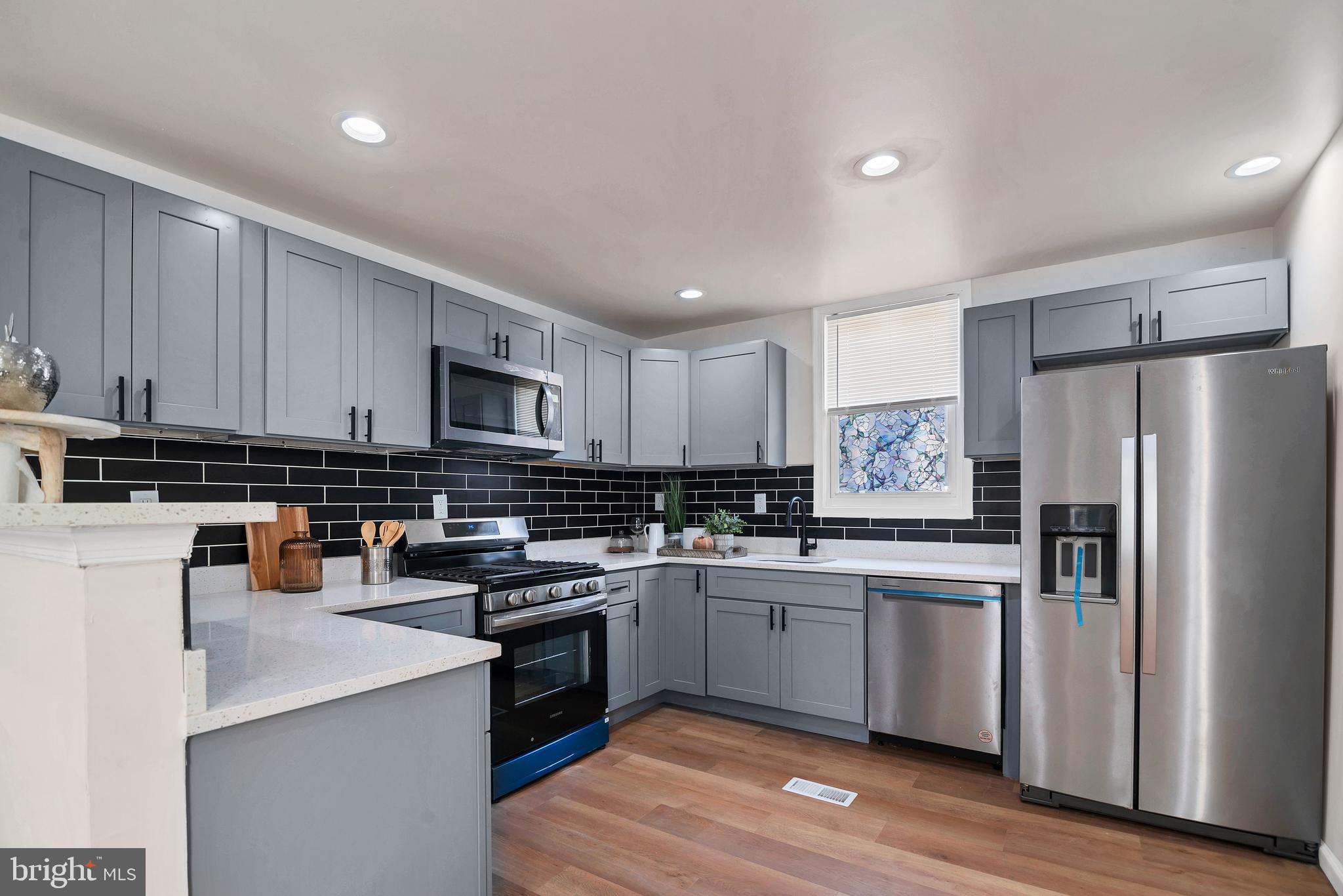 4132 Marx Avenue Baltimore, MD 21206 - Photo 21 of 76 a kitchen with cabinets a sink and stainless steel appliances