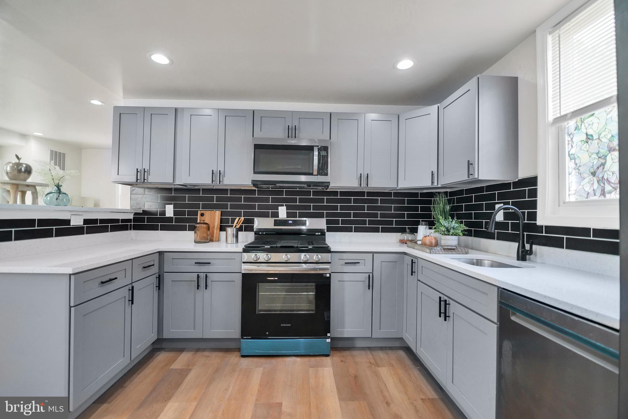 4132 Marx Avenue Baltimore, MD 21206 - Photo 22 of 76 a kitchen with cabinets appliances a sink and a window