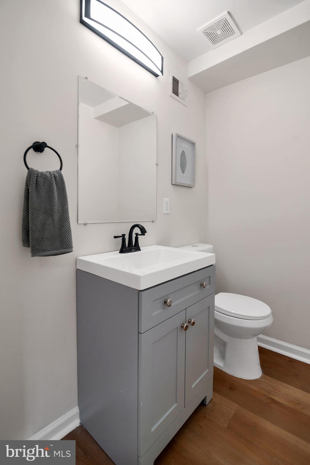 4132 Marx Avenue Baltimore, MD 21206 - Photo 26 of 76 a bathroom with a sink toilet and vanity
