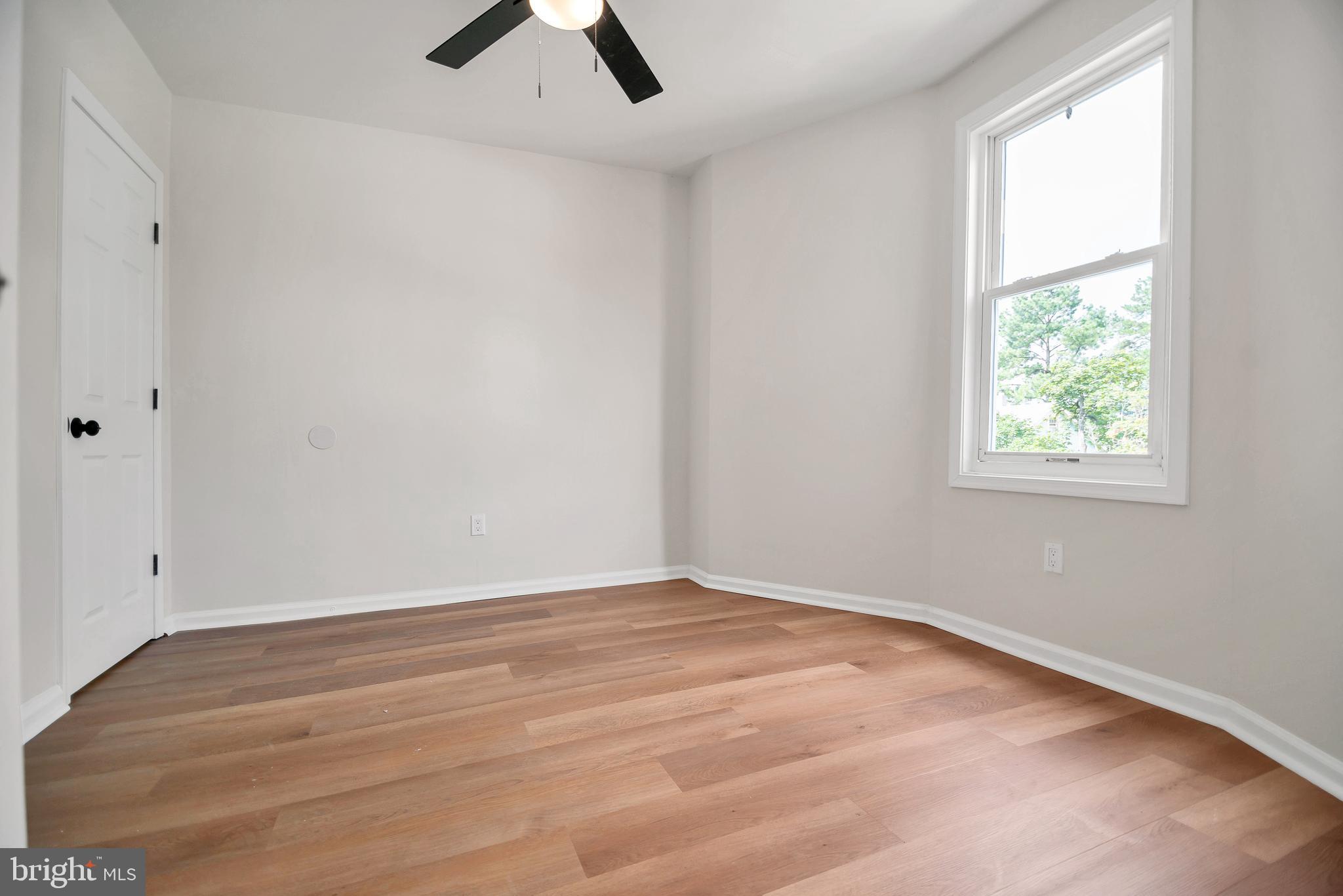 4132 Marx Avenue Baltimore, MD 21206 - Photo 34 of 76 an empty room with chandelier fan and windows