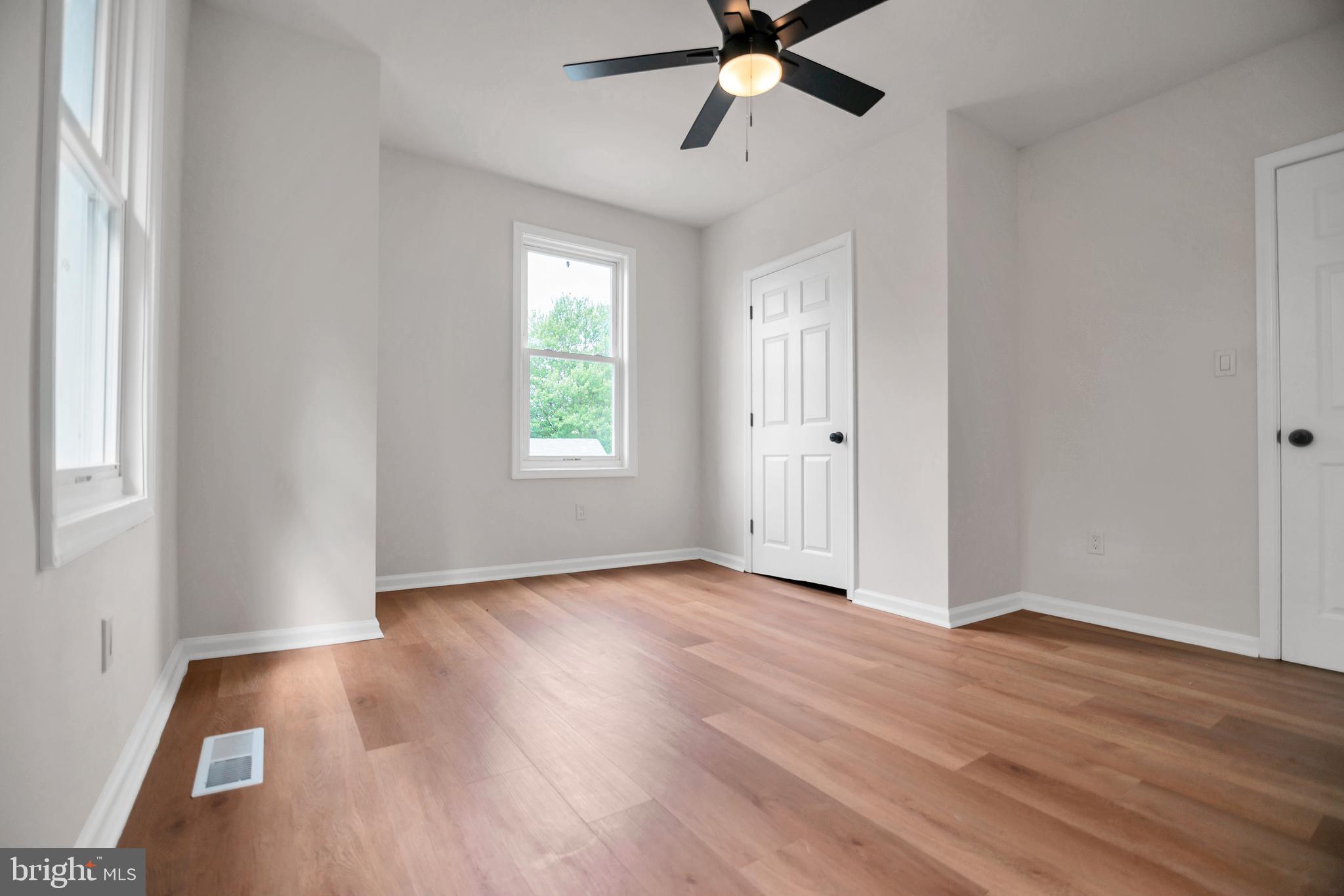 4132 Marx Avenue Baltimore, MD 21206 - Photo 36 of 76 an empty room with wooden floor fan and windows