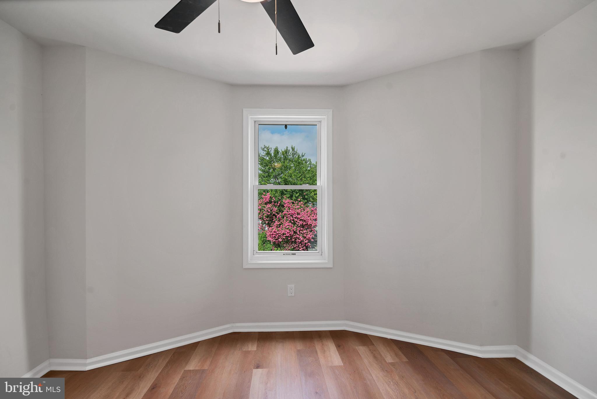 4132 Marx Avenue Baltimore, MD 21206 - Photo 37 of 76 an empty room with a window and wooden floor