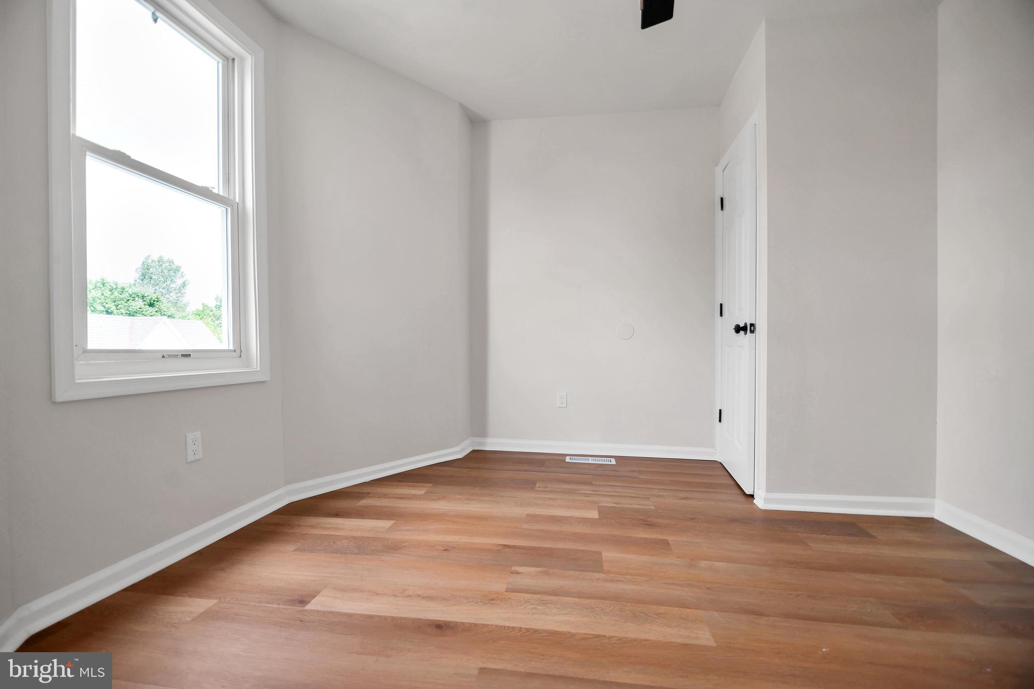 4132 Marx Avenue Baltimore, MD 21206 - Photo 38 of 76 a view of an empty room with wooden floor and a window