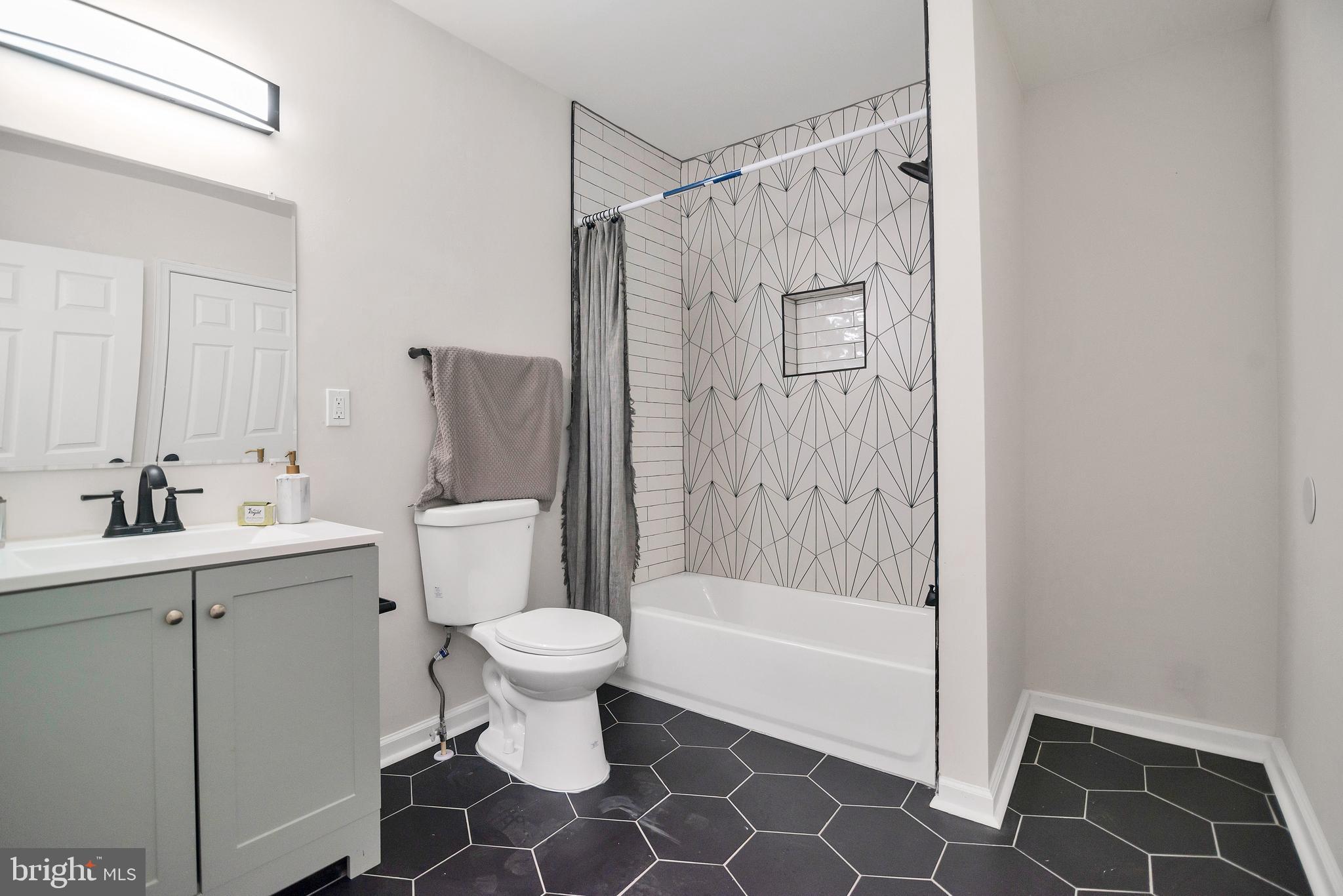 4132 Marx Avenue Baltimore, MD 21206 - Photo 40 of 76 a bathroom with a sink toilet and shower