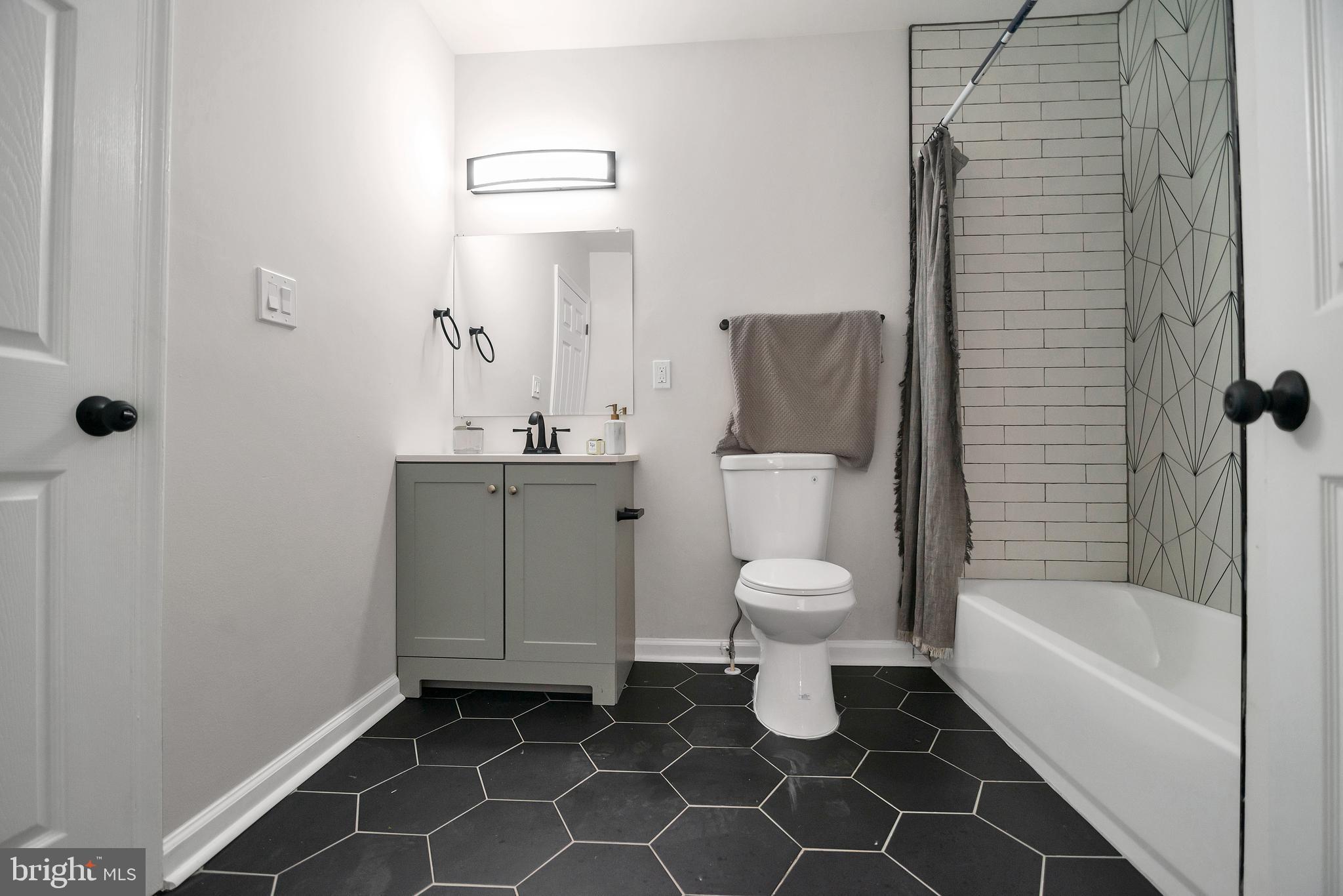 4132 Marx Avenue Baltimore, MD 21206 - Photo 41 of 76 a bathroom with a toilet sink and a bathtub