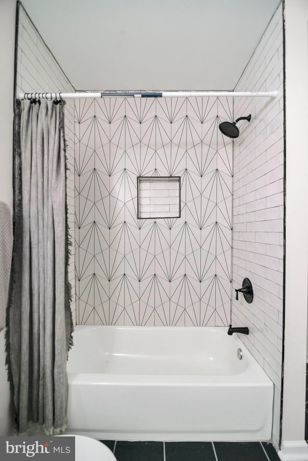 4132 Marx Avenue Baltimore, MD 21206 - Photo 42 of 76 a bathroom with a bathtub and shower