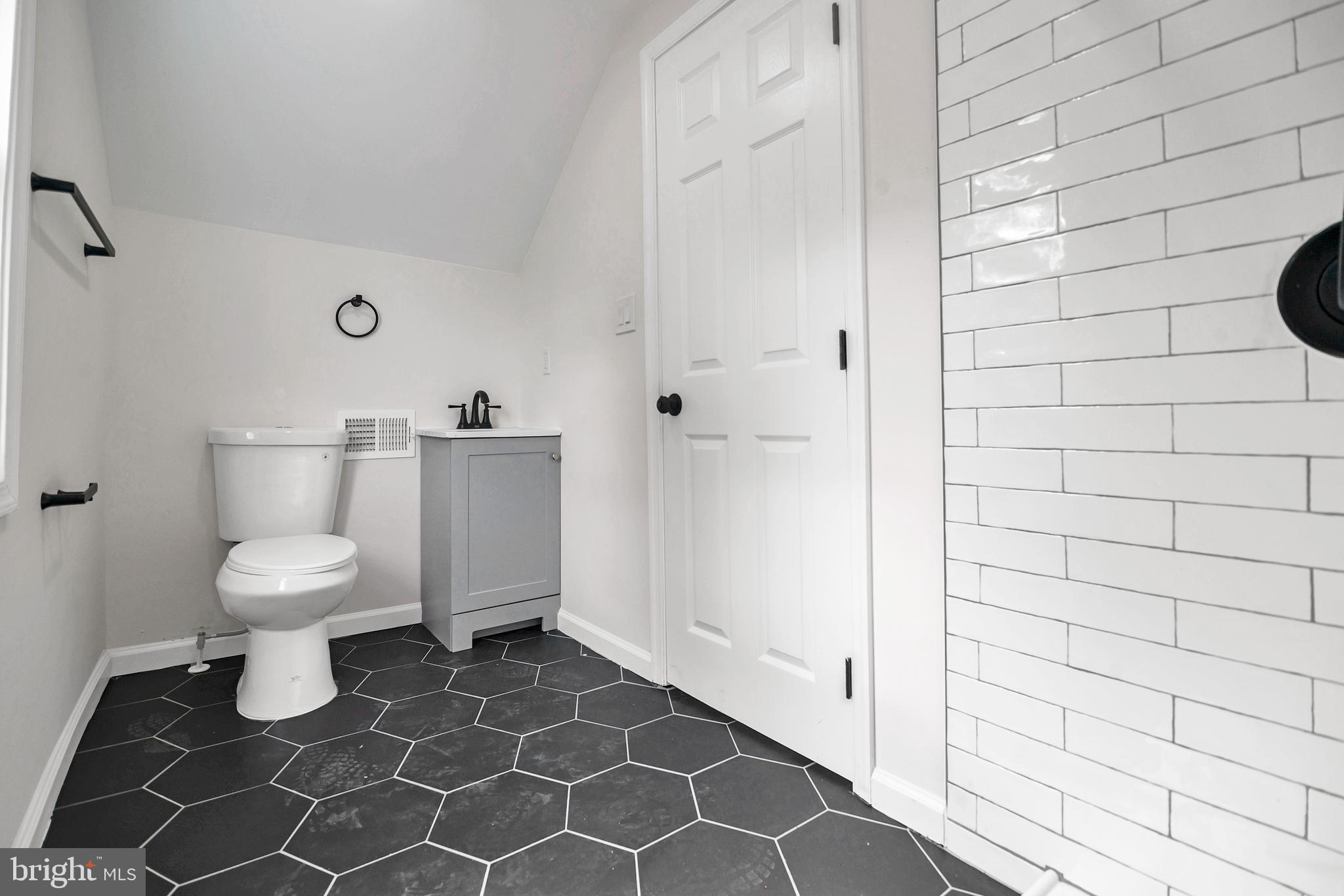 4132 Marx Avenue Baltimore, MD 21206 - Photo 53 of 76 a white toilet sitting next to a bathroom sink