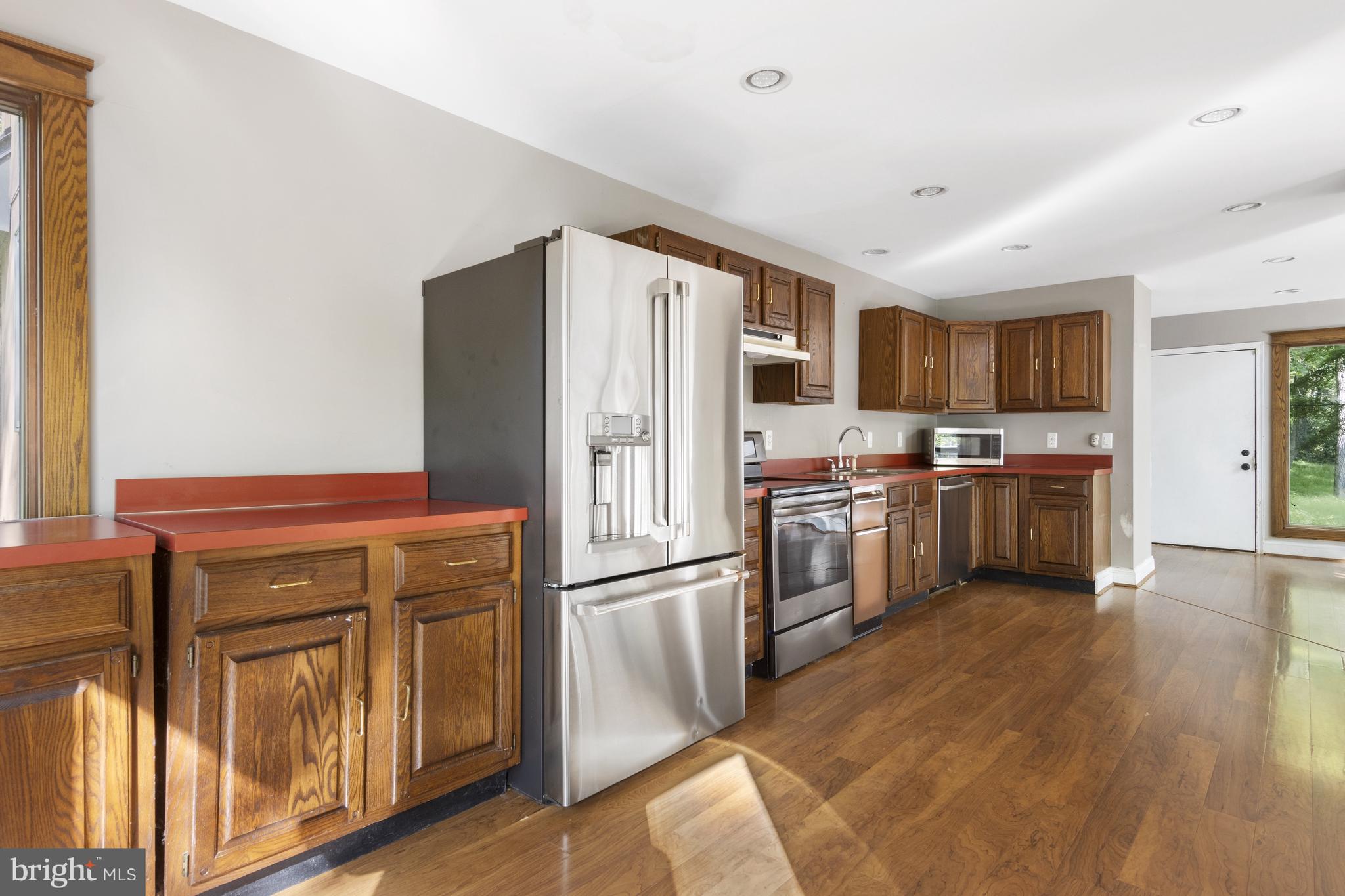 570 Chandler Mill Road Avondale, PA 19311 - Photo 19 of 41 a kitchen with stainless steel appliances a refrigerator and a stove top oven
