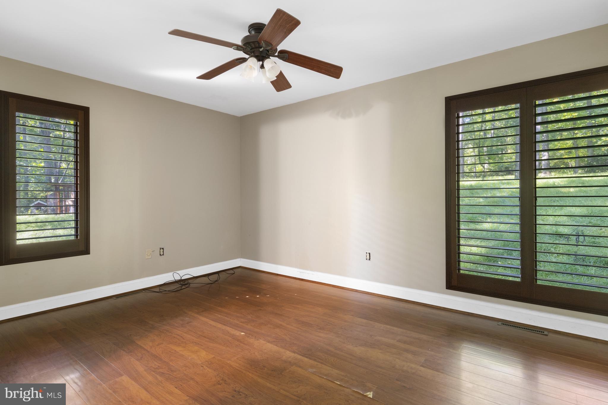 570 Chandler Mill Road Avondale, PA 19311 - Photo 26 of 41 an empty room with wooden floor and windows