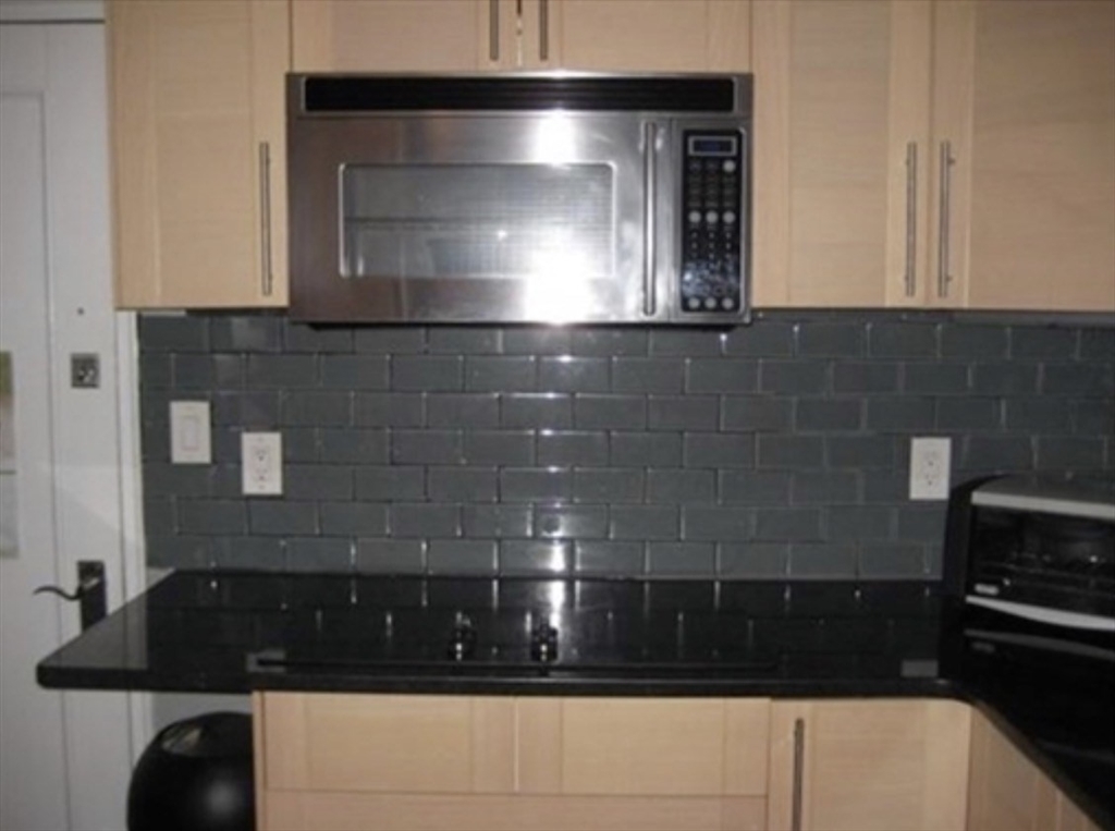 136 Boylston Street, Unit 1 Newton, MA 02467 - Photo 11 of 21 a bathroom with a sink and a granite counter top