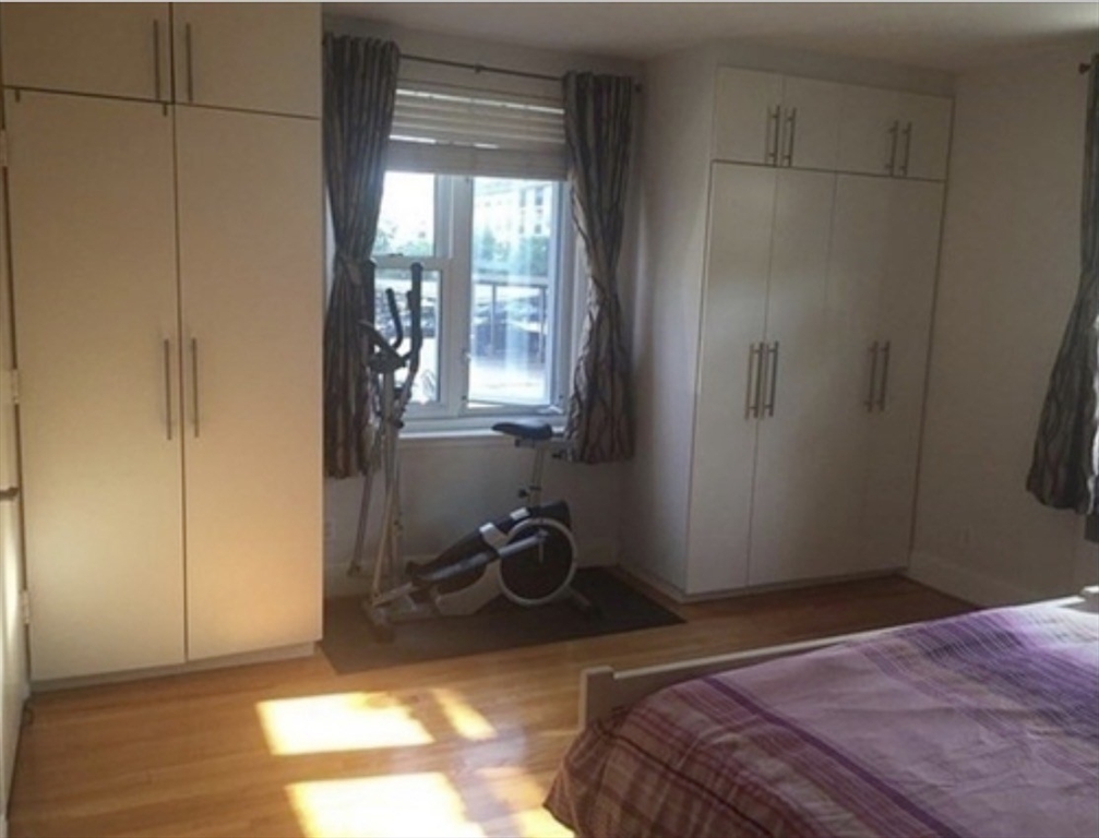 136 Boylston Street, Unit 1 Newton, MA 02467 - Photo 14 of 21 a bedroom with a bed and a window