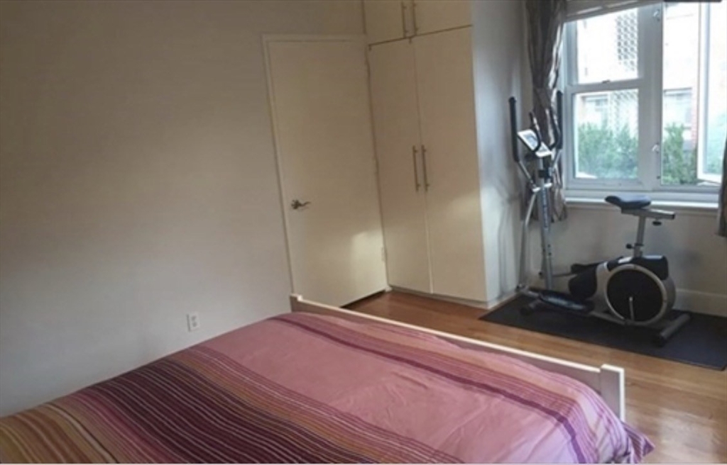 136 Boylston Street, Unit 1 Newton, MA 02467 - Photo 15 of 21 a bedroom with a bed and a window