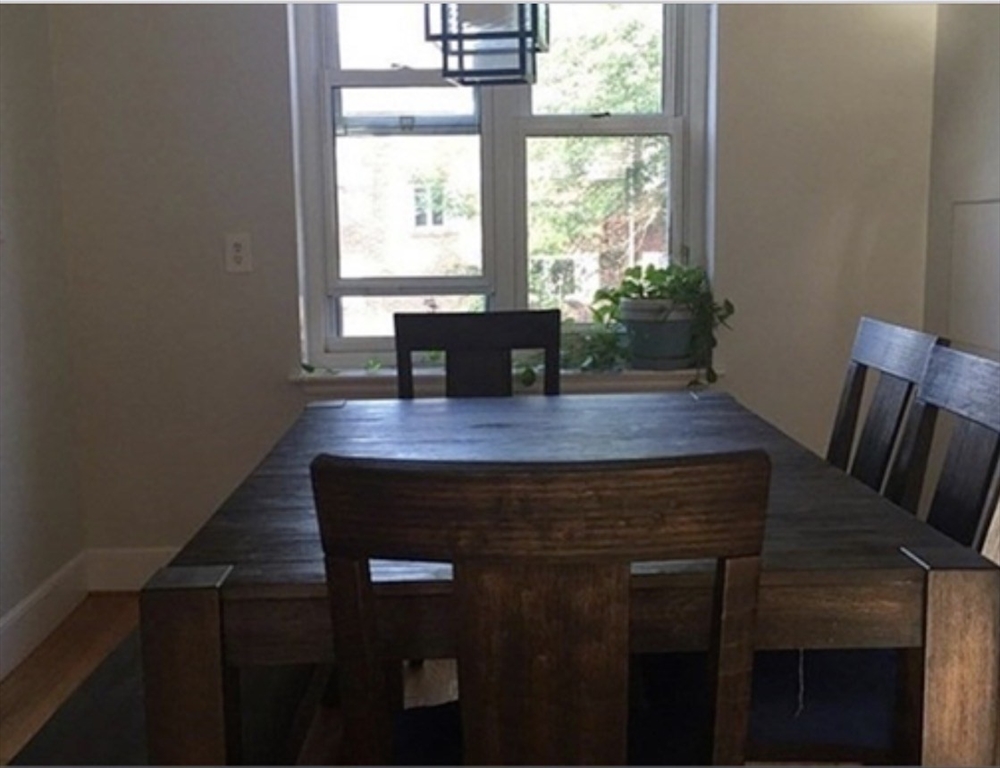 136 Boylston Street, Unit 1 Newton, MA 02467 - Photo 7 of 21 a view of a room with a table and chairs